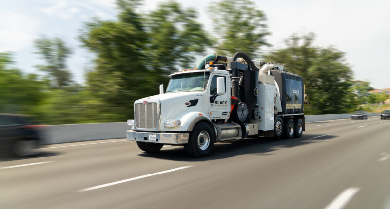 A large truck moving down a highway, captured in motion.